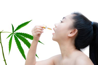 Woman holding a dropper sublingual Cannabis oil  clipart