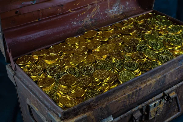 黒の背景に宝箱に金貨を積層 — ストック写真