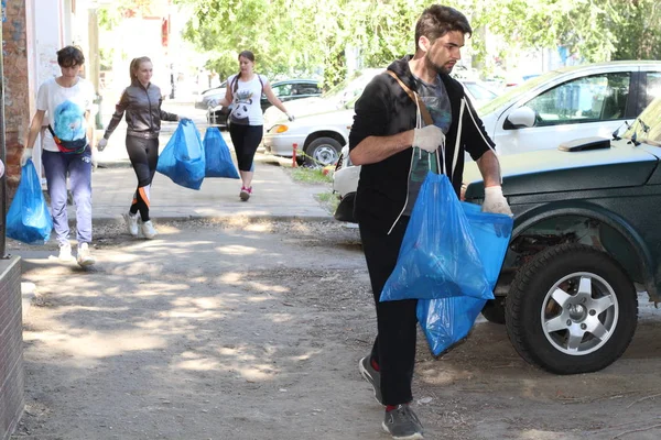 Plogging. anak perempuan berlari dan mengumpulkan sampah di dalam tas di jalanan Saratov, Rusia, 10 Juni 2018 — Stok Foto