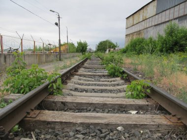 old abandoned railroad with rusty rails and rotting sleepers clipart