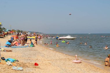 Bir grup tatilci sıcak plajların keyfini çıkarabilir. Rusya, Golubitskaya - Haziran, 2018