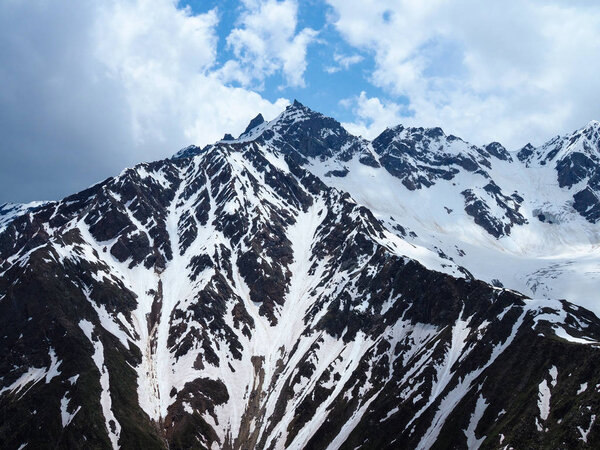 Beautiful view of the melting snow Cheget mountains in summer in Sunny weather