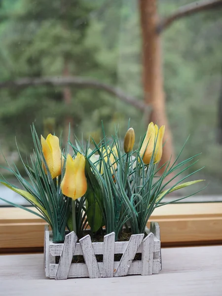 artificial flowers in crafting pots on a wooden windowsill, ecodesign