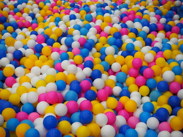 Colorful child balls. Multi-colored plastic balls. childrens playroom. Background texture of multi-colored plastic balls on playground — Stock Photo, Image