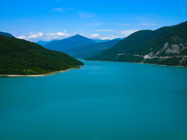 Красивий краєвид з видом на велике блакитне озеро в горах, покритих лісом . — стокове фото