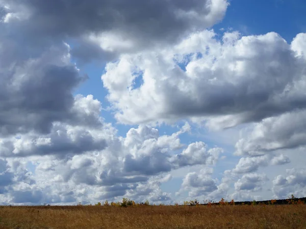 Beautiful sky with big clouds over the field Stock Photo