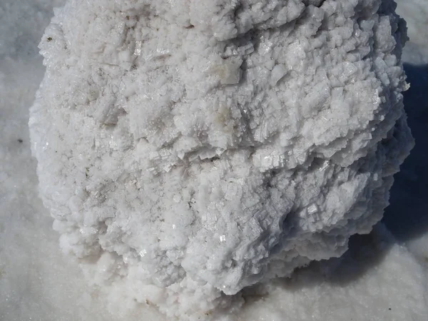 salt block, a huge block of salt on which structured grains of salt are visible