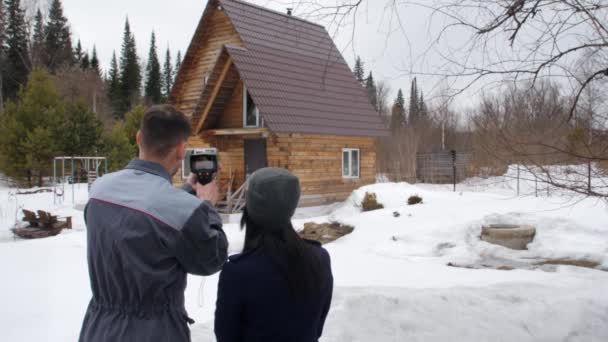 Ritratto del lavoratore della casa che sta effettuando un'ispezione da parte della termocamera. Mostrare ai posti di problema di cliente. Risparmio energetico . — Video Stock