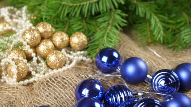 Creation of a table Christmas composition. Transition frame with Christmas toys on a candlestick of spruce, cones and tangerines. Close up — Stock Video