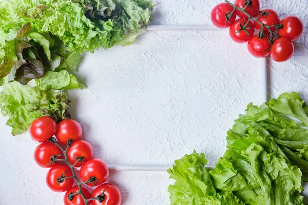 frame for copy space with lettuce and cherry tomatoes on a background