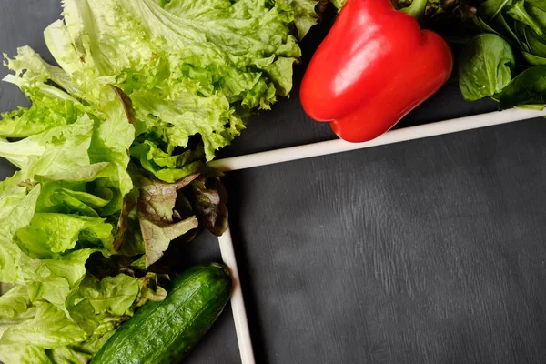 frame for copy space with lettuce,lemon, pepper, cucumbers and cherry tomatoes on a white background