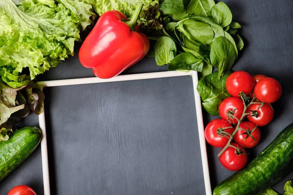 frame for copy space with lettuce,lemon, pepper, cucumbers and cherry tomatoes on a white background