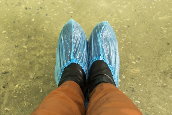 feet blue Shoe covers in the hospital the patient. Cleanliness in the clinic