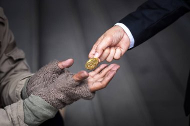 businessman give, donate, his gold bitcoin to homeless man in downtown of business zone clipart