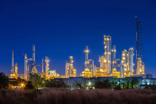 night after sunset time with agriculture field and chemical plant petrochemical and petroleum plant with reactor and distillation for chemical process in industrial