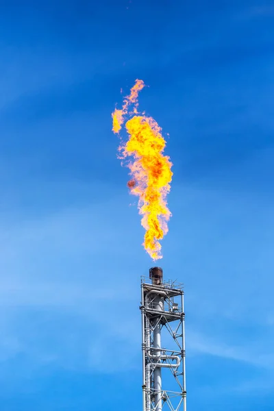 fume of fire on flare stack to burning heat gas, pollution in environment, for power and safety in petrochemical, chemical refinery or power plant in industrial zone