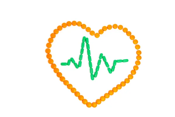 A pulse is by green pills in the orange heart Isolated on white background. — Stock Photo, Image