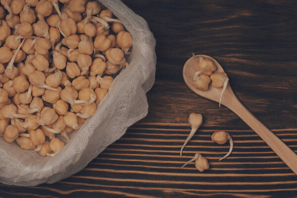 closeup  of chickpea sprouts on wooden background 