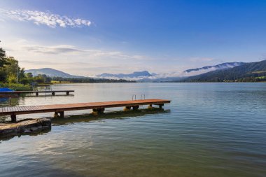 Panorama of a lake with a jetty, Irrsee, Austria clipart