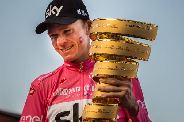 Roma, Italy May 27, 2018: Chris Froome, in pink jersey, celebrates the victory of 101th Giro D'Italia 2018 on the podium in Rome and holds the infinite trophy in his hands.