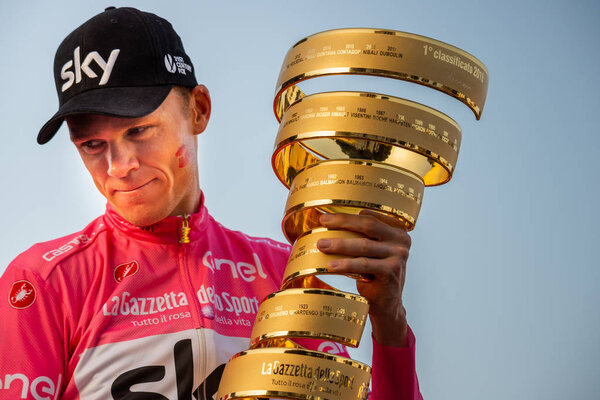 Roma, Italy May 27, 2018: Chris Froome, in pink jersey, celebrates the victory of 101th Giro D'Italia 2018 on the podium in Rome and holds the infinite trophy in his hands.