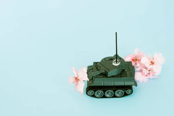 war machine with a flower in the back, peace and war, military action, a flower in the barrel of a tank, a concept on the army, free space, copy space, space for text, victory day, may 9, world war