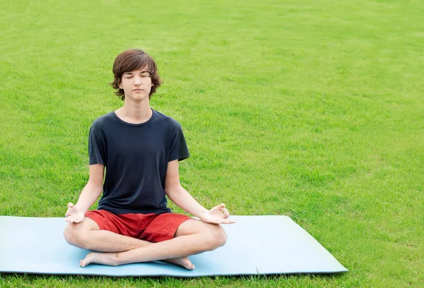Young Man Long Hair Does Yoga Outdoors Teenager Sits Lotus — Stock Photo, Image
