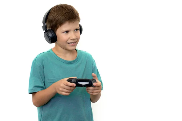 Boy plays a computer game with headphones and a joystick, game console. — Stock Photo, Image