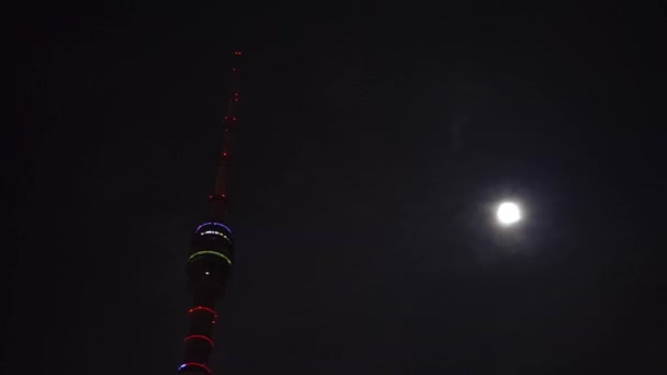 The highest construction in Europe, Ostankino television tower near full moon.4K — Stock Video