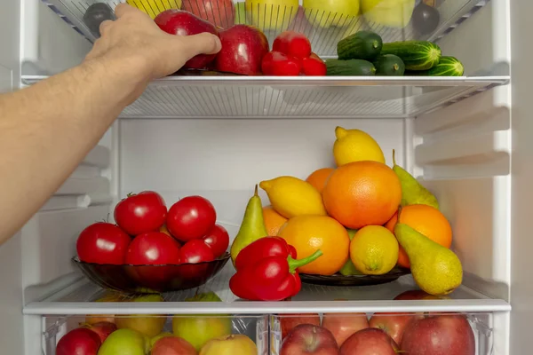 Fridge Filled Useful Products Vegetables Fruits Man Hand Takes Red — Stock Photo, Image
