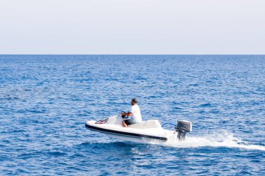 İnsanlar üzerinde deniz taşıtları sürme. Yaz eğlencesi. Deniz taşıtları üzerinde sürme için etkin olan kişileri.