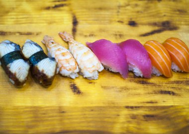 Suşi çubukla yemek. Suşi restoranında Japon gıda rulo. California suşi roll somon, sebze, uçan balık roe ve havyar closeup ile ayarlayın. Japonya restoran menü