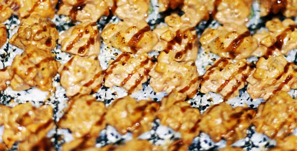 Sushis on plate at japanese restaurant banner panoramic background. Closeup of Aburi Oshi sushi, seared salmon box pressed vinegared rice, Osaka region, Japan travel. Header crop.