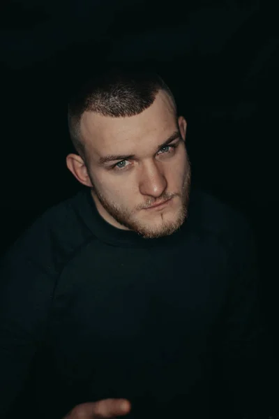 Handsome bearded guy. Dark studio photos