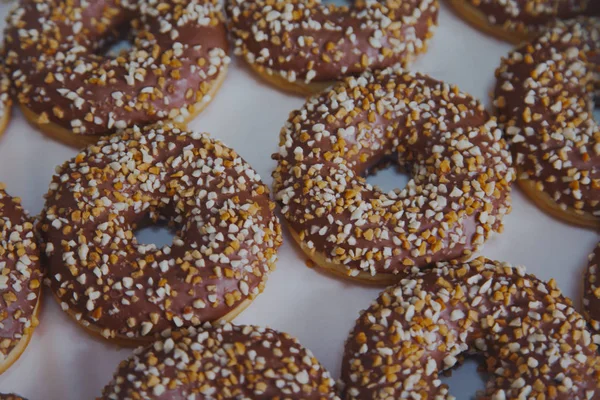 Chocolate donut with nuts. Chocolate donut with chopped almonds. Donut on white background