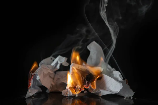 Burning paper on a black background. Ash, fire.