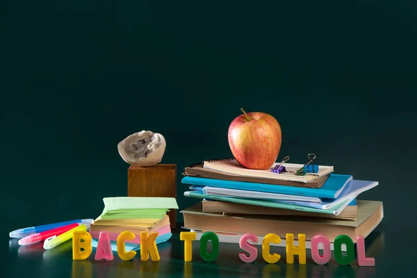 Terug naar school. Stilleven met schoolbenodigdheden. Groene achtergrond. Notebooks, notebooks, viltstiften. — Stockfoto