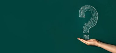Soru işareti beyaz tebeşir yeşil bir Chalkboard üzerinde çizilir. Bir çocuğun elleri. Kavramsal