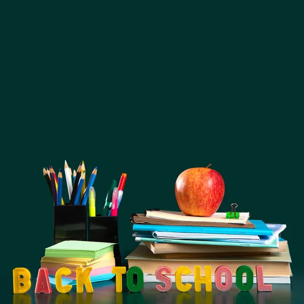 Inscription BACK TO SCHOOL. Still life with school supplies. Notebooks, notebooks, felt-tip pens, colored pencils, an apple. Colorful picture. Copy space — Stock Photo, Image