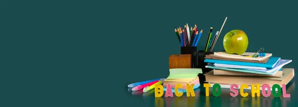 Inscription BACK TO SCHOOL. Banner.  Still life with school supplies. Notebooks, notebooks, felt-tip pens, colored pencils, an apple. Colorful picture. Copy space — Stock Photo, Image