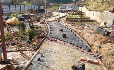 Yeni bir yol bir siyah tuğla ve kırmızı mermer kaldırım taşı güneşli bir sonbahar gününde bir konut yapı yerinde düzenleme