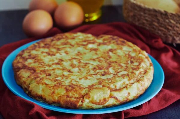 Spanisches Omelett mit Kartoffeln, Ei und Zwiebeln, begleitet von Olivenöl — Stockfoto