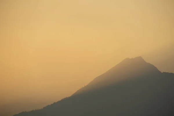 A mountain illuminated by the golden glow of sunset