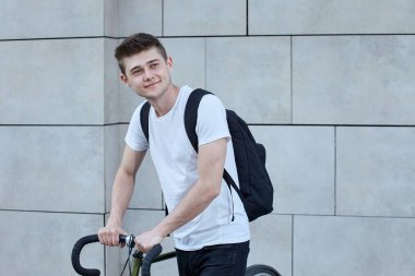 Şehirde bisiklet ile poz yakışıklı hipster adam.