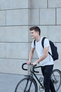 Şehirde bisiklet ile poz yakışıklı hipster adam.