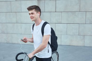 Şehirde bisiklet ile poz yakışıklı hipster adam.