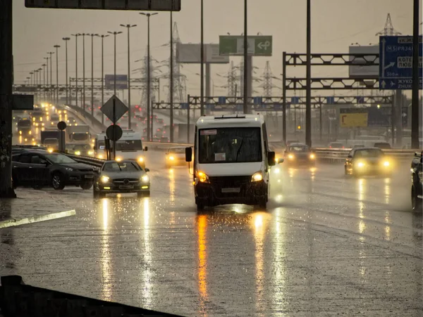 City highway in the evening with cars during the rain