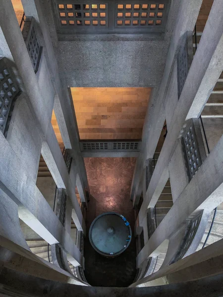 Old building inside stone staircase looking down into the deep