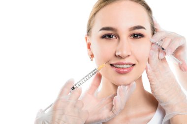 Güzellik uzmanının elleri, izole edilmiş beyaz arka planda kadınlara yüz gerdirme ameliyatı yapıyor. Yenilenme ve kozmetoloji kavramı