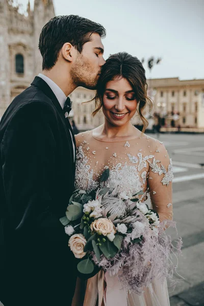 Bride and groom at Italian wedding in middle of Milan, Italy